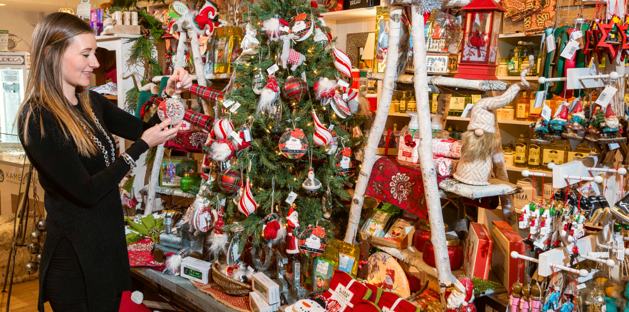 Shopper admiring holiday ornaments at Pear Home in Orangeville